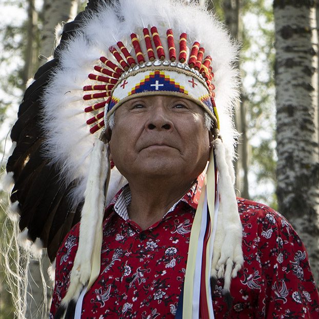 Man with trees background.